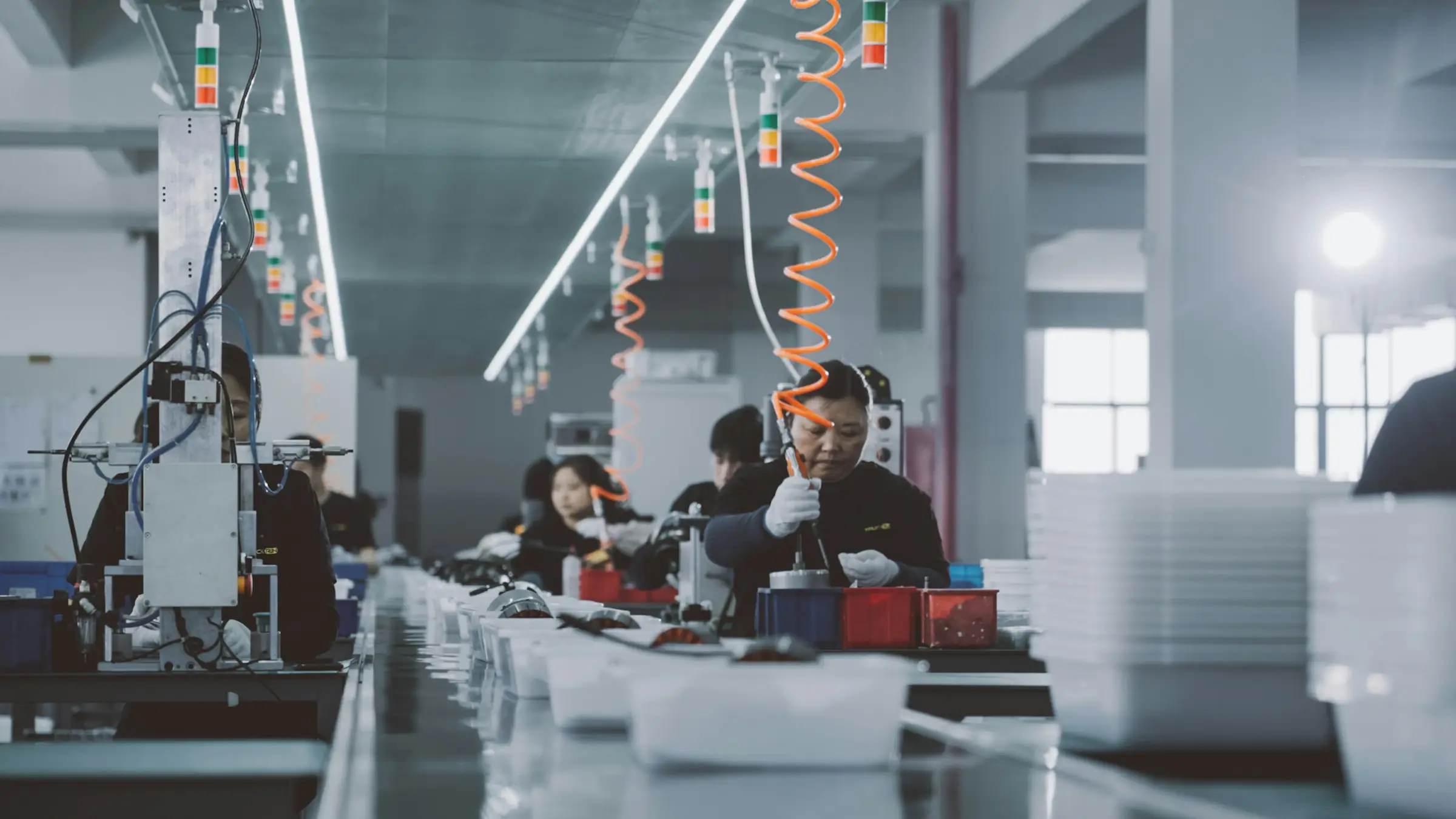 Workers at an assembly line in a modern factory