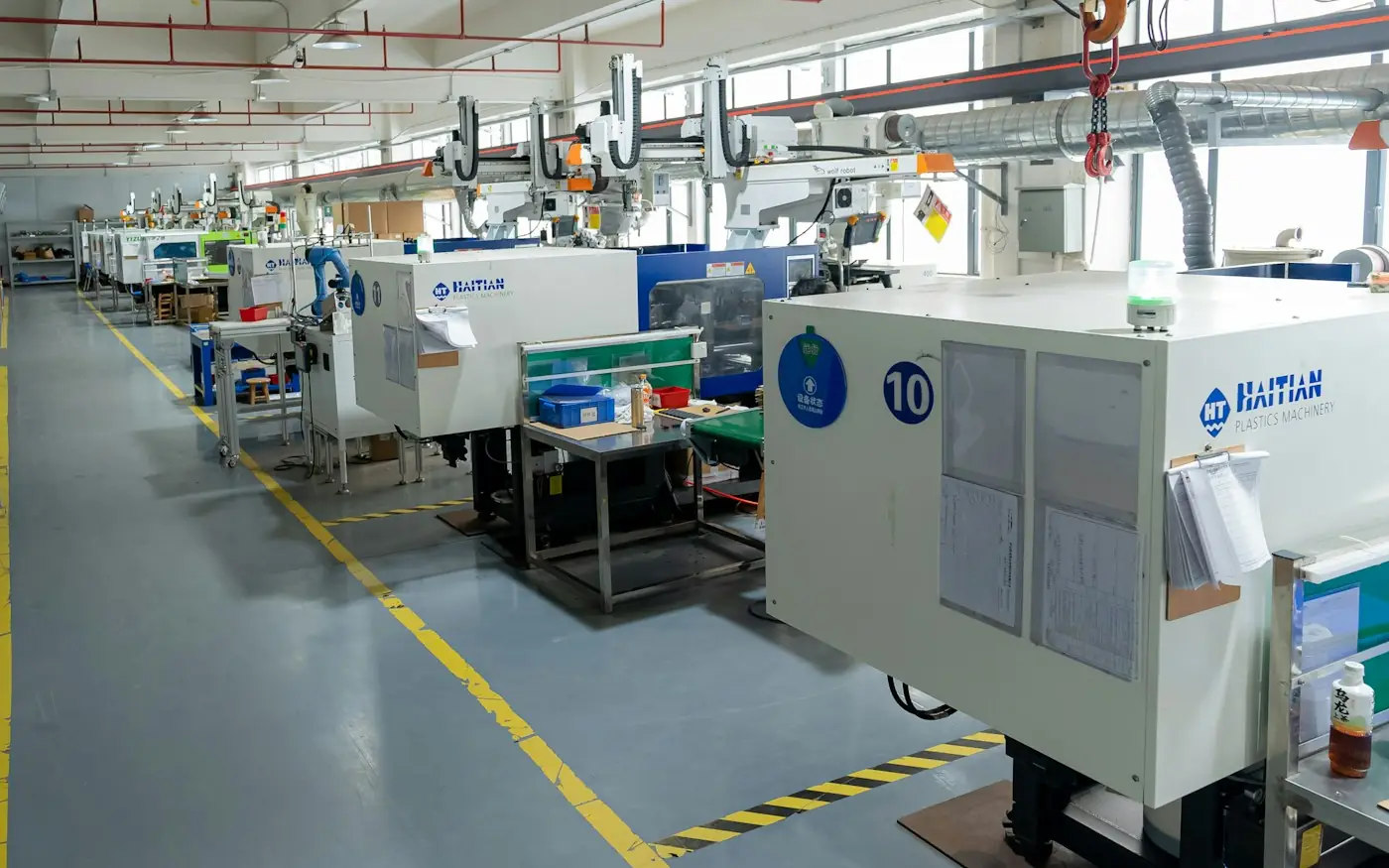 Row of injection molding machines on a factory floor