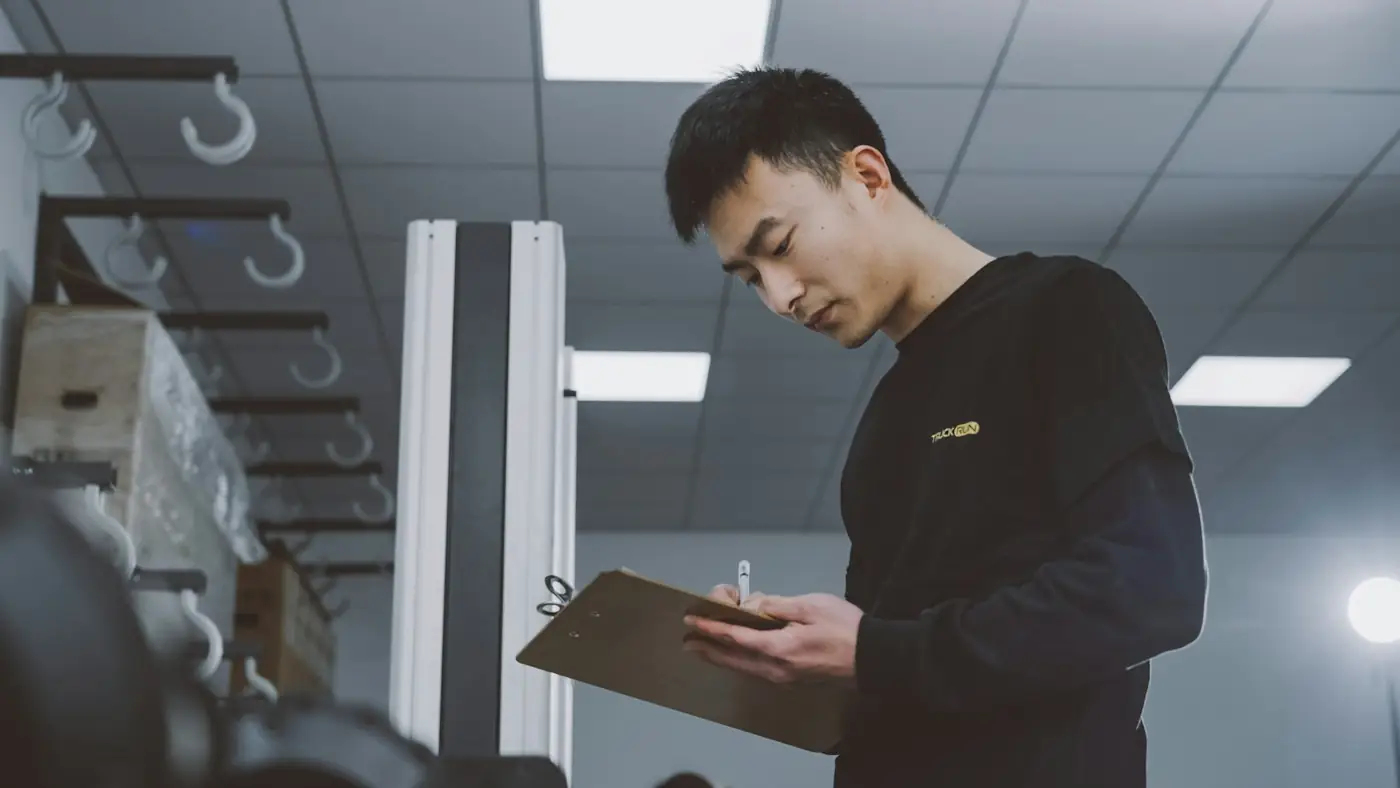 Production supervisor reviewing a checklist on the factory floor